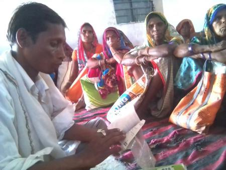 Dinesh Raisingh conducting meeting with victims.jpg